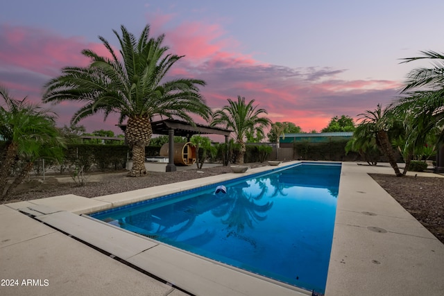 pool at dusk with a patio