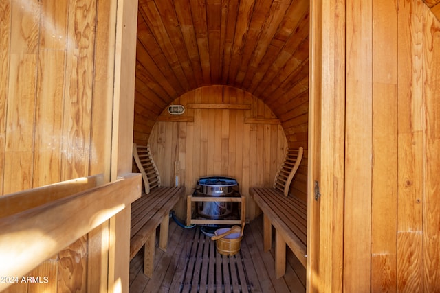 view of sauna / steam room featuring wood ceiling, hardwood / wood-style flooring, and wood walls