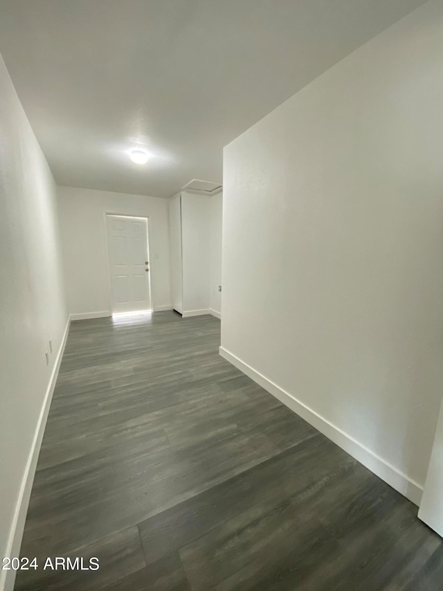 spare room featuring dark wood-type flooring