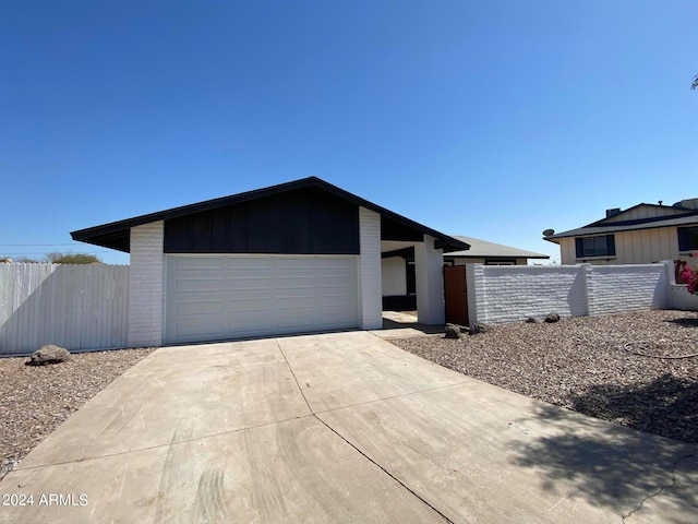 single story home featuring a garage and an outbuilding