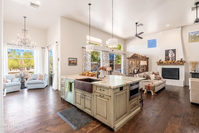 kitchen with cream cabinetry, dark hardwood / wood-style floors, sink, hanging light fixtures, and appliances with stainless steel finishes