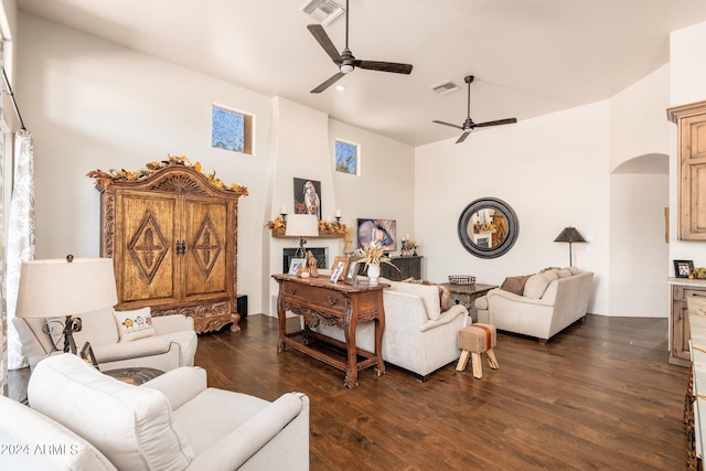 living room featuring dark wood-type flooring and ceiling fan