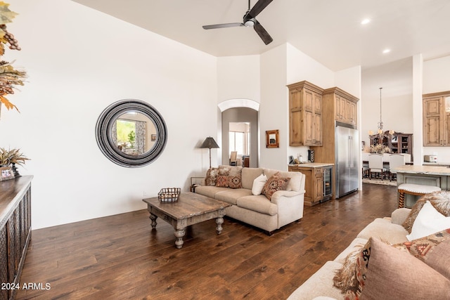 living room with ceiling fan, wine cooler, and dark hardwood / wood-style flooring