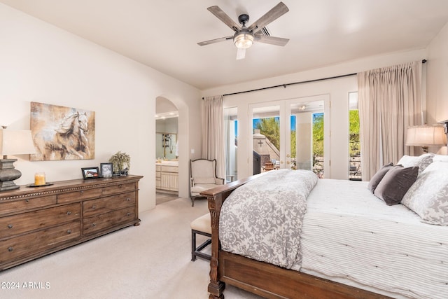 carpeted bedroom featuring access to exterior, ensuite bathroom, and ceiling fan