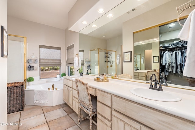 bathroom with tile patterned flooring, plus walk in shower, and vanity