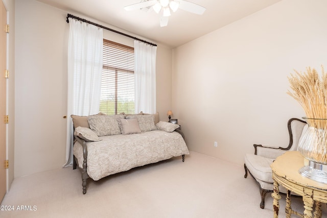 living area with ceiling fan and carpet flooring