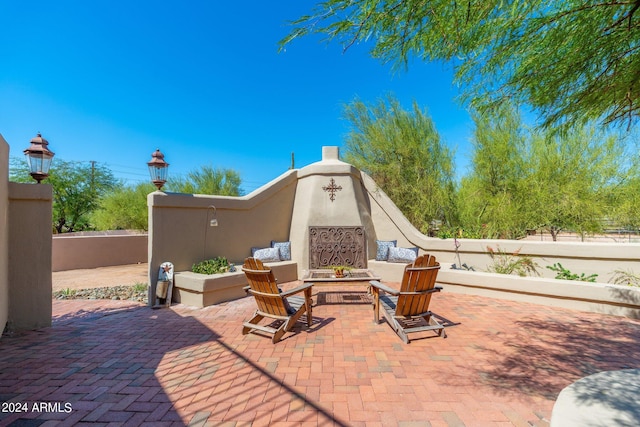 view of patio with exterior fireplace