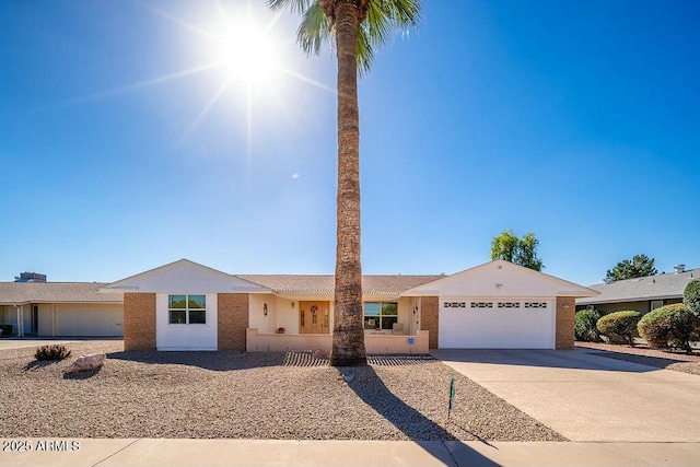 single story home featuring concrete driveway and an attached garage