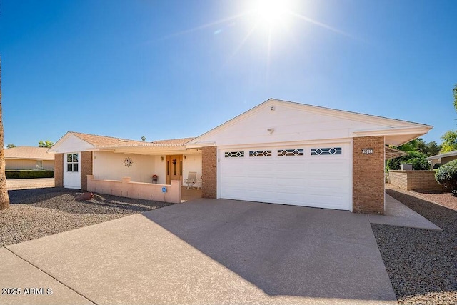 view of front of property featuring concrete driveway and an attached garage