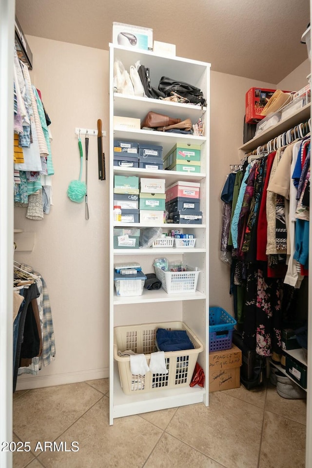 spacious closet featuring tile patterned flooring