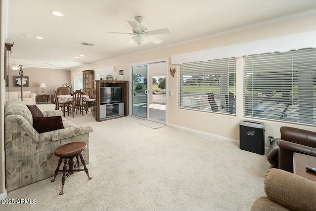 carpeted living area featuring ornamental molding, visible vents, and baseboards