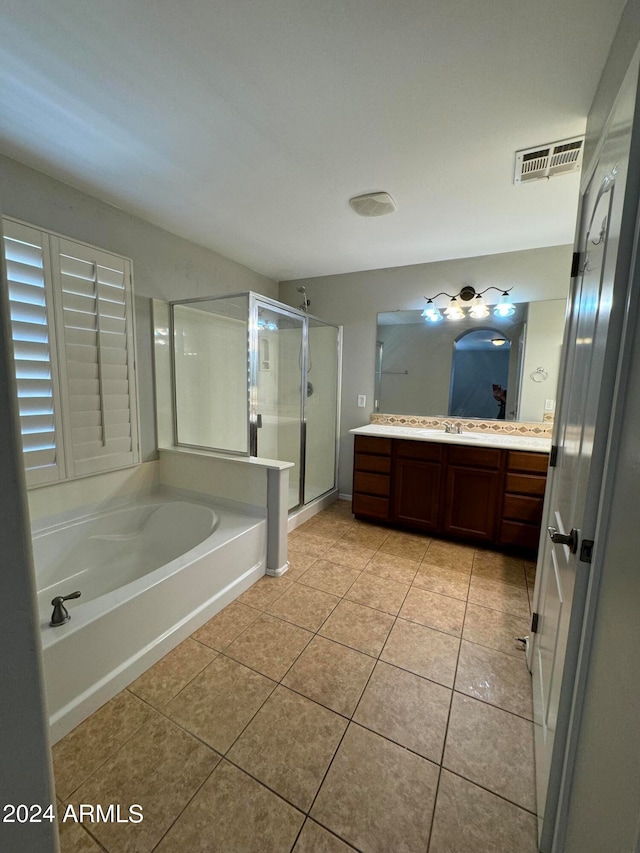 bathroom featuring tile patterned floors, vanity, and separate shower and tub