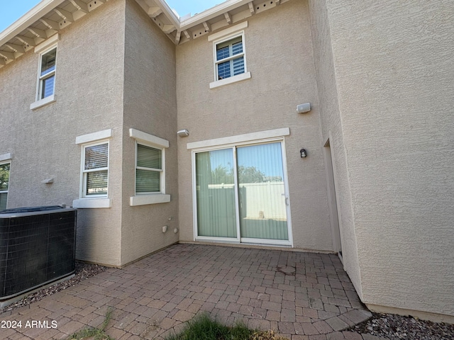 rear view of property with a patio area and central air condition unit