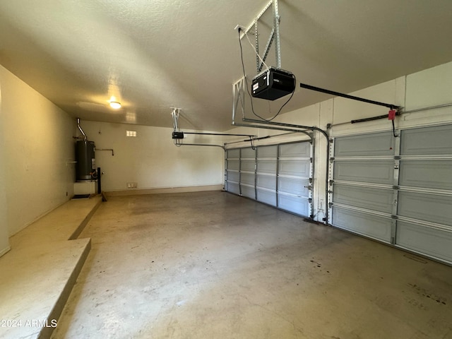 garage featuring a garage door opener and water heater