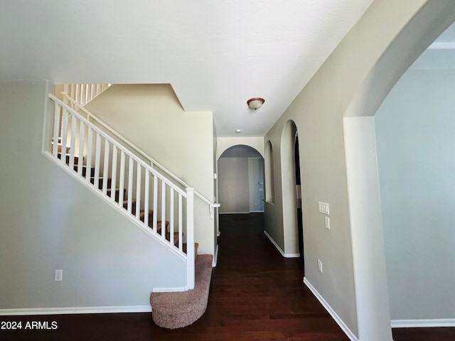 corridor with dark hardwood / wood-style flooring