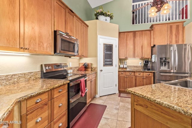 36641 N Railway St, San Tan Valley, AZ 85140 - kitchen featuring stainless steel appliances, an inviting chandelier, light stone counters, and light tile patterned flooring
