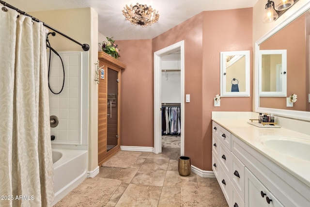 36641 N Railway St, San Tan Valley, AZ 85140 - bathroom with a walk in closet, shower / bathtub combination with curtain, vanity, and baseboards
