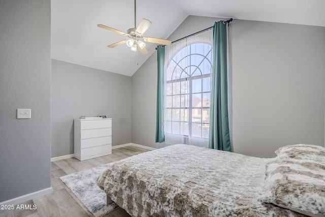 bedroom with lofted ceiling, ceiling fan, and light wood-type flooring