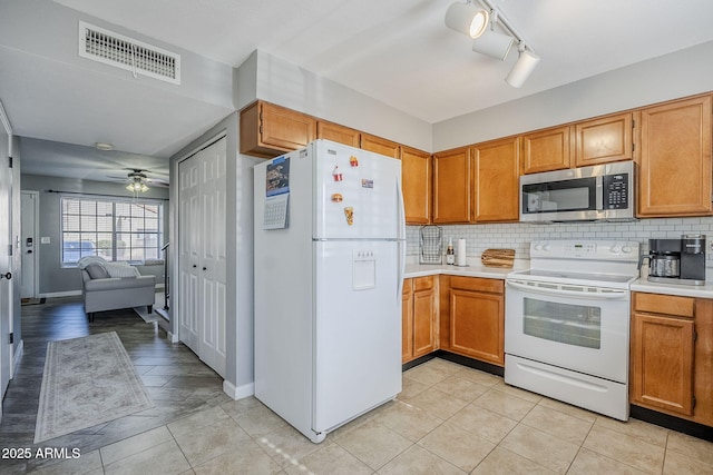 kitchen with light tile patterned floors, white appliances, decorative backsplash, and ceiling fan