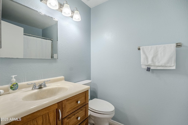 bathroom with vanity and toilet