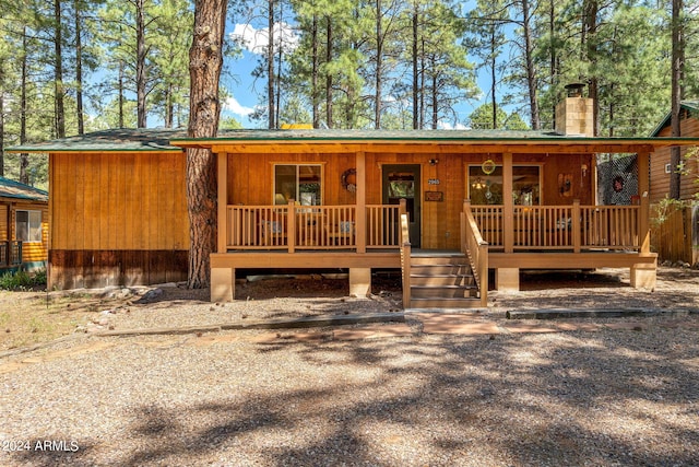 2965 Lone Star Dr, Overgaard, AZ 85933 - view of front facade with covered porch and a chimney