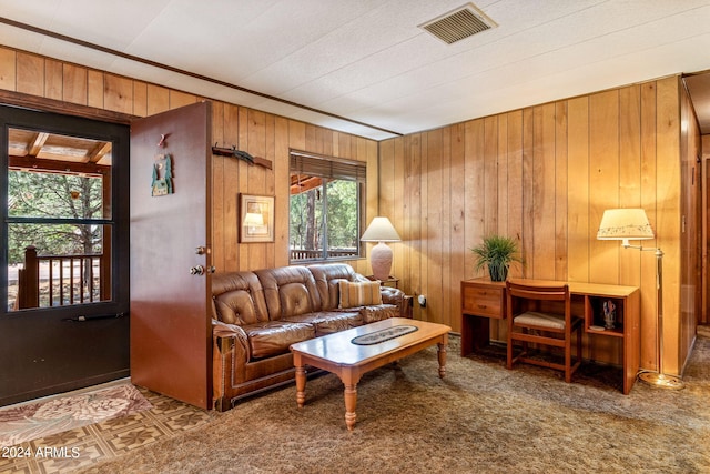 living room with wooden walls and carpet flooring