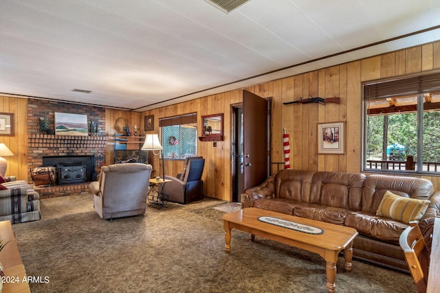 living room with brick wall, carpet flooring, wooden walls, and a fireplace