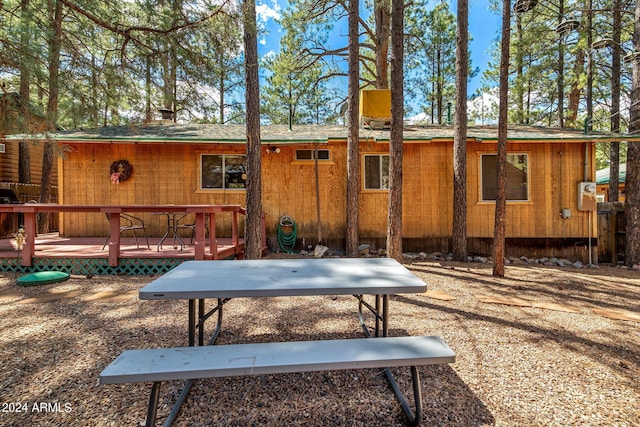 rear view of property with a wooden deck