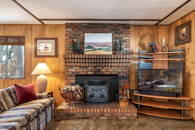 living room with brick wall, wood walls, a brick fireplace, and carpet floors