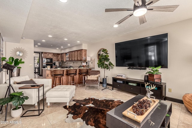 10826 E Navajo Dr, Sun Lakes, AZ 85248 - living room featuring a textured ceiling, ceiling fan, recessed lighting, and baseboards