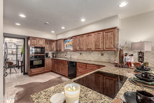 10826 E Navajo Dr, Sun Lakes, AZ 85248 - kitchen featuring black appliances, brown cabinets, tasteful backsplash, and a sink