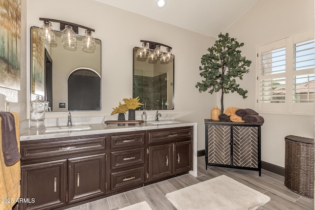 10826 E Navajo Dr, Sun Lakes, AZ 85248 - bathroom with double vanity, wood finished floors, tiled shower, and a sink