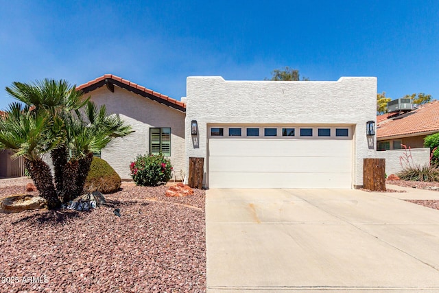 10826 E Navajo Dr, Sun Lakes, AZ 85248 - view of front of home with stucco siding, a tiled roof, central AC unit, concrete driveway, and an attached garage