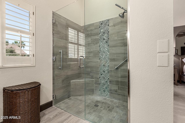 10826 E Navajo Dr, Sun Lakes, AZ 85248 - full bathroom featuring a stall shower, a textured wall, wood finished floors, and a healthy amount of sunlight