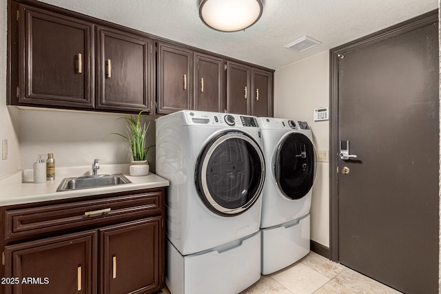 10826 E Navajo Dr, Sun Lakes, AZ 85248 - laundry area featuring separate washer and dryer, cabinet space, a sink, visible vents, and a textured ceiling