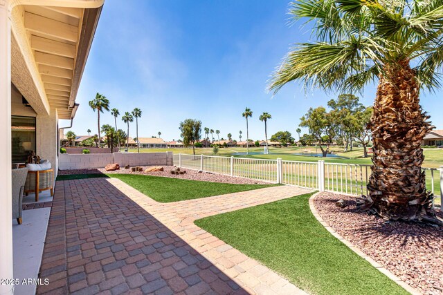 10826 E Navajo Dr, Sun Lakes, AZ 85248 - view of yard with a patio, a fenced backyard, and view of golf course
