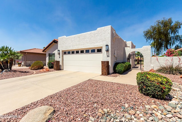 10826 E Navajo Dr, Sun Lakes, AZ 85248 - view of front of home featuring stucco siding, a gate, fence private yard, driveway, and an attached garage