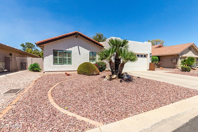 10826 E Navajo Dr, Sun Lakes, AZ 85248 - ranch-style home featuring driveway, a tile roof, stucco siding, fence, and a garage
