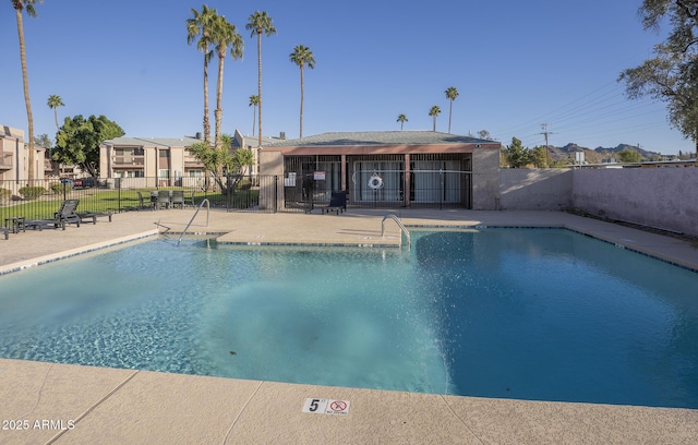 community pool featuring a patio and fence