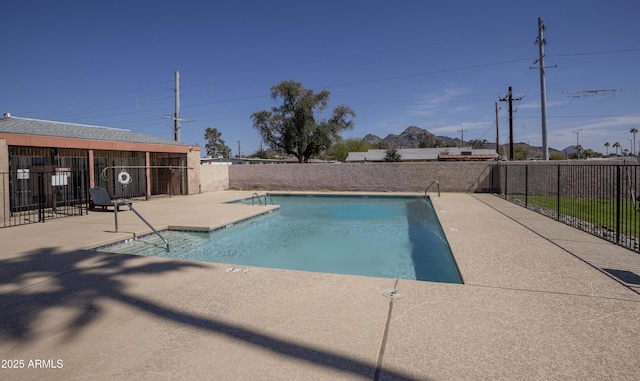 pool featuring a fenced backyard and a patio