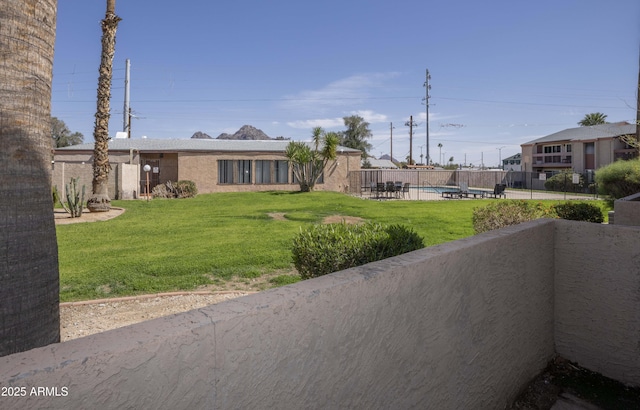 view of front of property featuring a fenced in pool, a front lawn, and fence