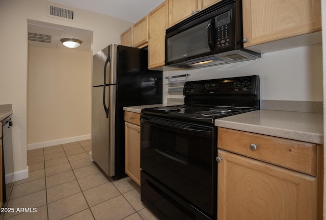 kitchen with visible vents, black appliances, light brown cabinets, light countertops, and light tile patterned floors