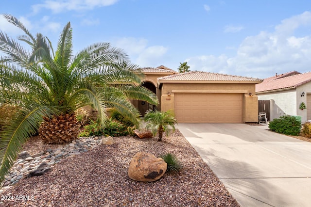 mediterranean / spanish-style home with a garage