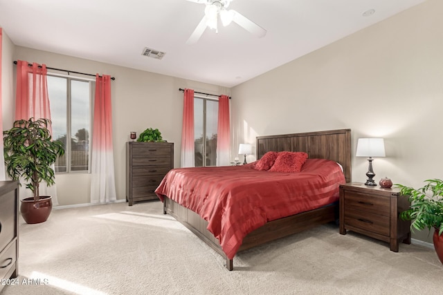 carpeted bedroom featuring ceiling fan and vaulted ceiling