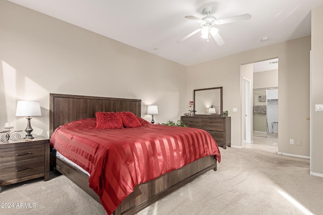 bedroom with ensuite bath, ceiling fan, and light carpet