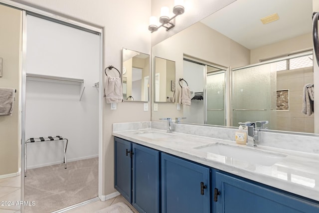 bathroom with vanity and a shower with shower door