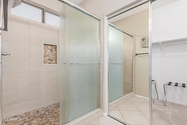 bathroom with tile patterned flooring and an enclosed shower