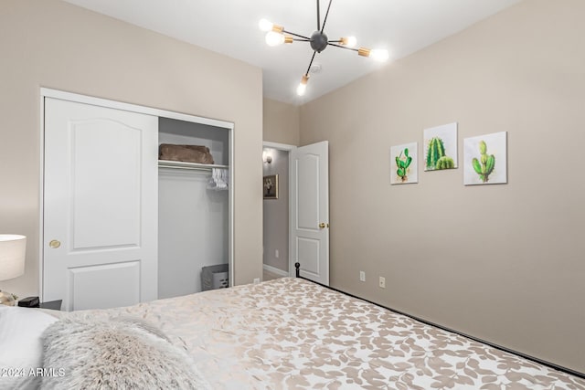 bedroom with a closet and an inviting chandelier