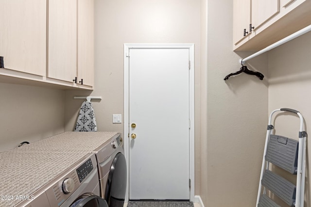 clothes washing area with cabinets and independent washer and dryer