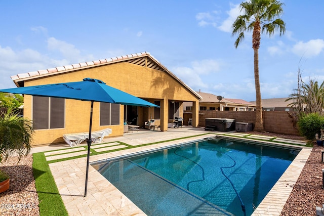 view of swimming pool featuring a patio area and a hot tub